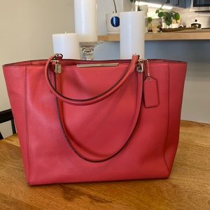 Pink Coach bag with zip top.